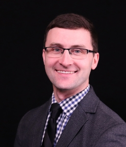 Man with glasses smiling