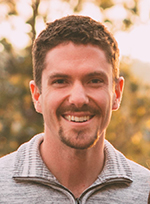 Head and shoulder shot of a middle-aged man with a moustache and beard