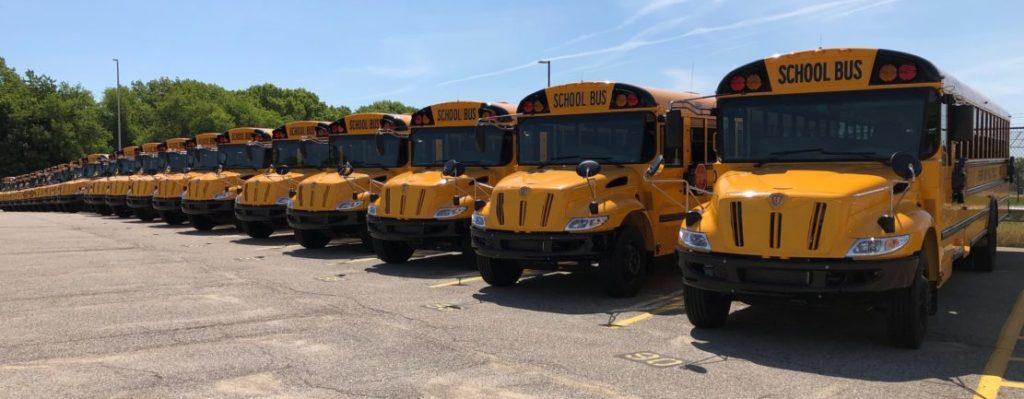 a fleet of parked school buses