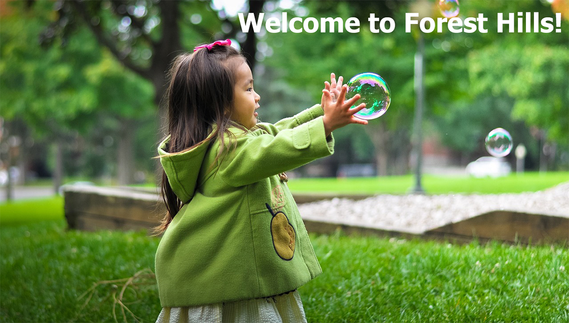 a little girl catching bubbles outside